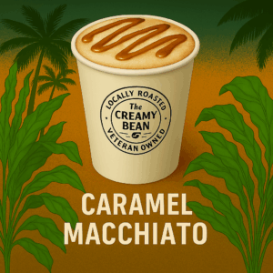 Hot Caramel Macchiato in a white to-go cup with caramel drizzle and The Creamy Bean logo
